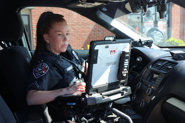 Nixa Police Officer working on laptop in vehicle