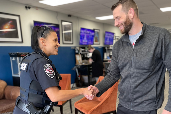 https://www.nixa.com/wp-content/uploads/2022/08/Officer-Trafford-shakes-hands-with-business-owner.png