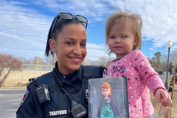 Nixa Police Officer Trafford with gift for girl