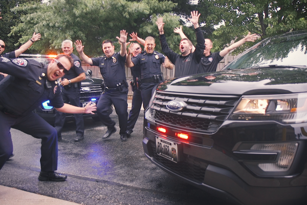 Nixa Police dancing in front of patrol cars