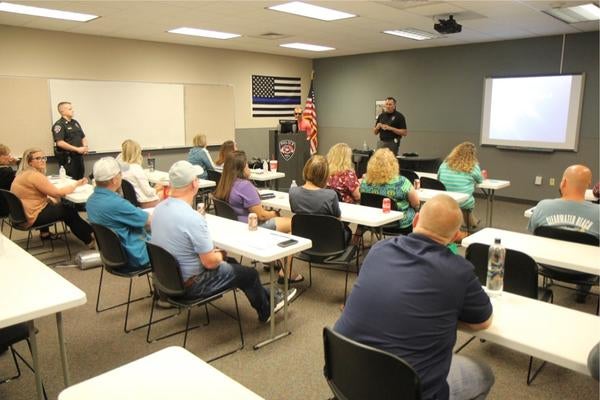 students sitting in Nixa citizen police academy classroom