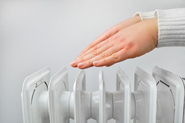 Hands warming by heater