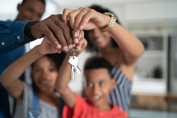 Family holding key to their new home