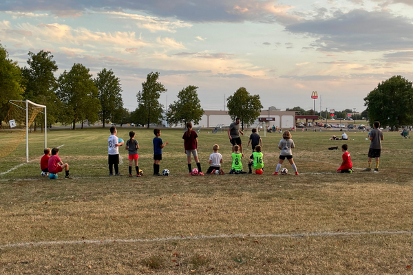 Kids lined up at soccer field
