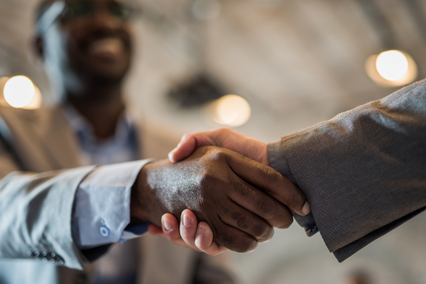 two people shake hands